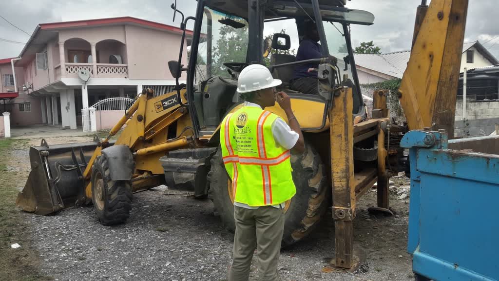 A Jamaal's Industrial crew and backhoe working on a construction site in Trinidad
