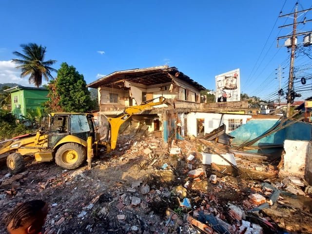 A Jamaal&rsquo;s Industrial crew and backhoe demolishing a building on a site in Trinidad